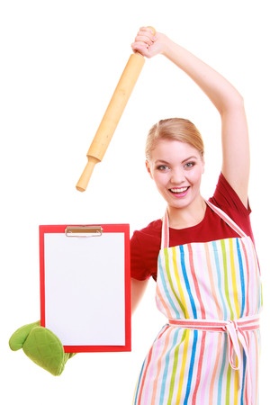 Excited woman in an apron holding rolling pin, clipboard and wearing oven glove