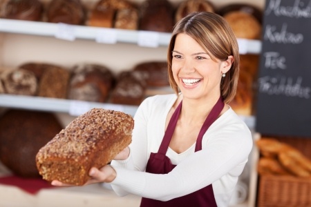 Lady smiling at a loaf of bread